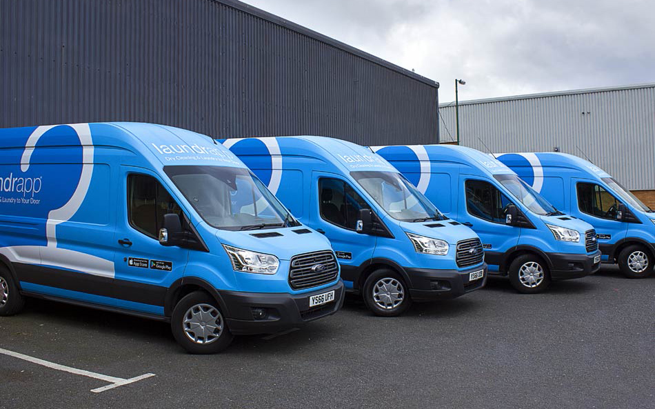 Large wrapped vans in a row